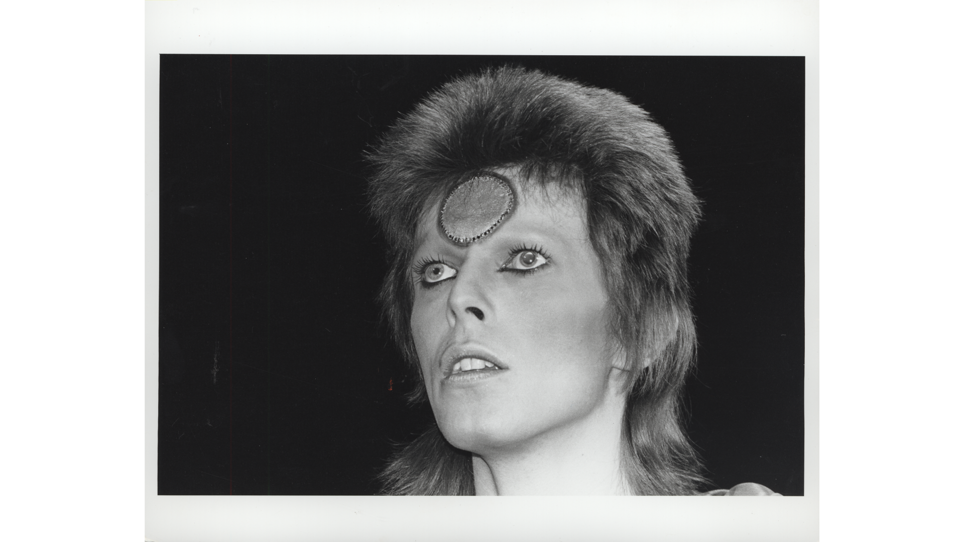 David Bowie performing on the Ziggy Stardust tour, 1973 © Mick Rock 1973, Estate of Mick Rock 2025